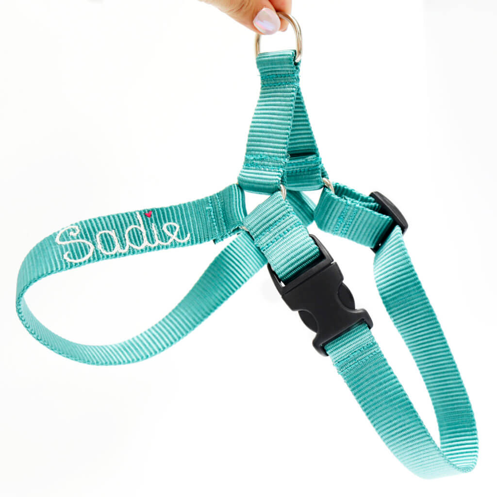 Teal colored pet harness with the name Sadie embroidered directly onto the nylon fabric